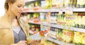 Lady reading the nutrition facts of food packages